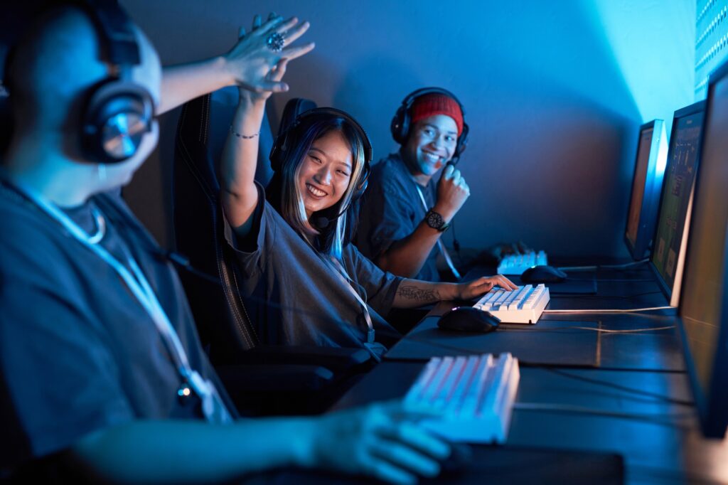 Asian female gamer high five teammate